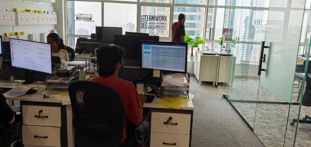 Alnahrain team working in the Sharjah office open-plan workspace